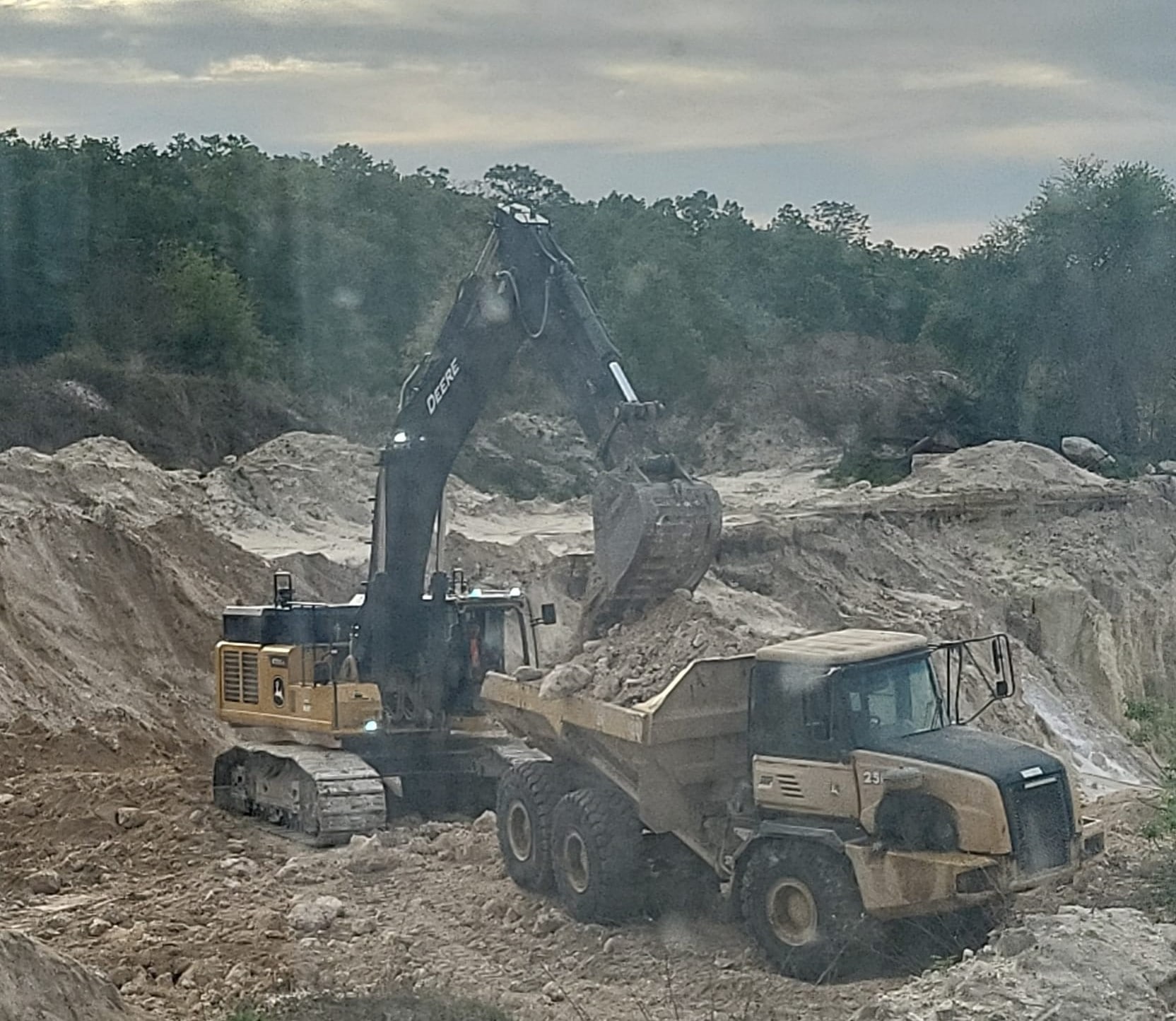 Excavator Loading Truck At Rock Mining